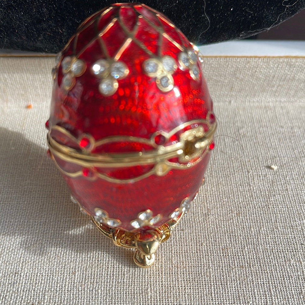 Egg jewelry box. Red enamel egg opens up.